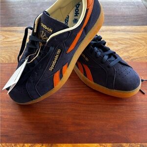 Reebok Men’s Navy Suede Club C Grounds Sneakers with Orange Stripes